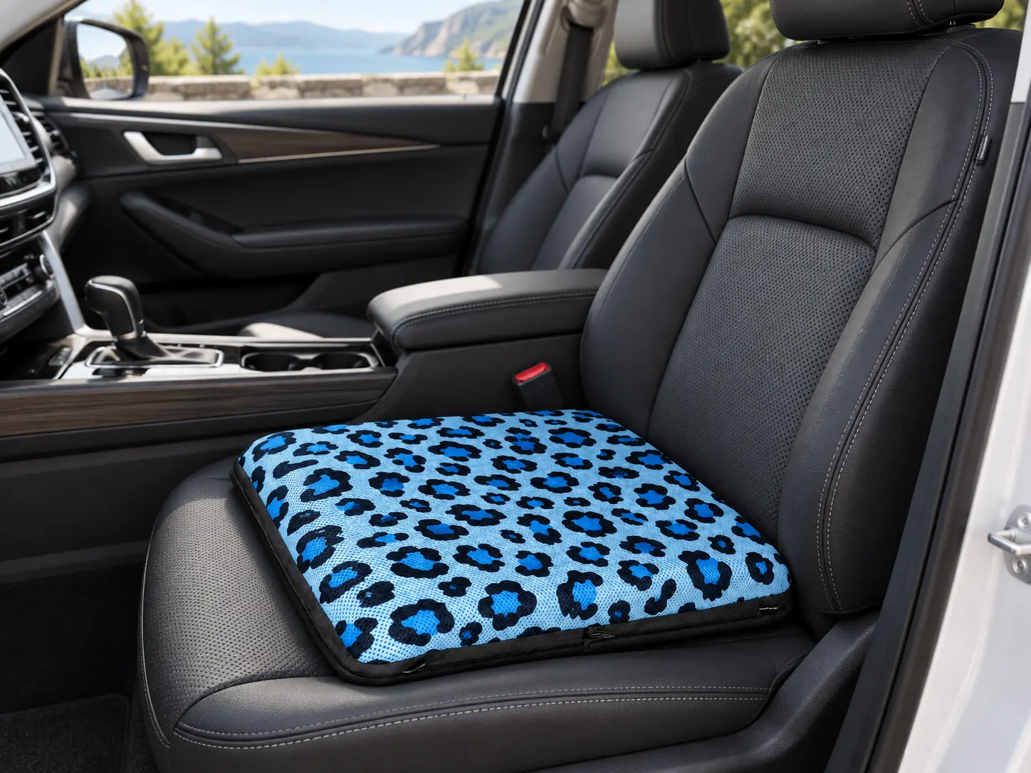 AJ blue leopard print air seat cushion resting flat on a dark car seat.