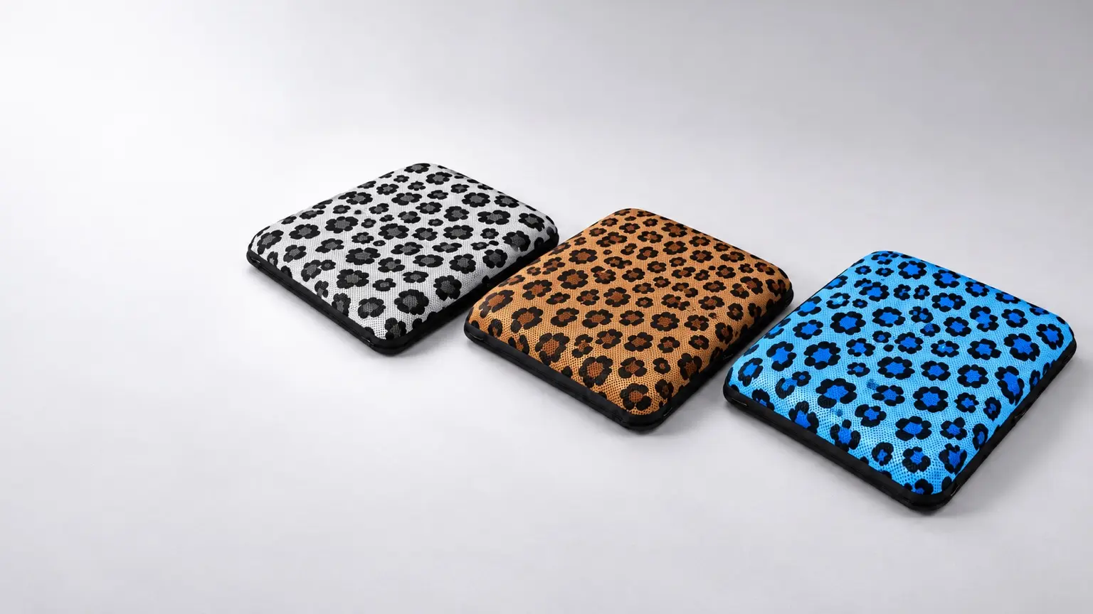 Gray, brown and blue AJ leopard print air seat cushions with breathable 3D mesh and black trim, arranged on a light gray background.